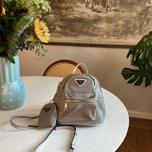 Prada mini grey backpack with gold hardware. Excellent condition!
